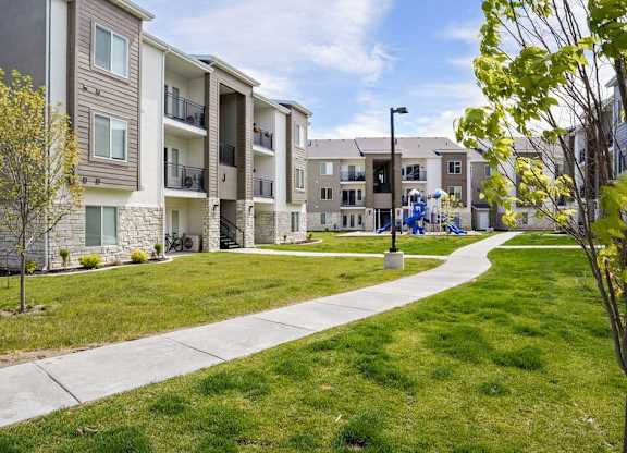 Apartment complex with a walkway in front.