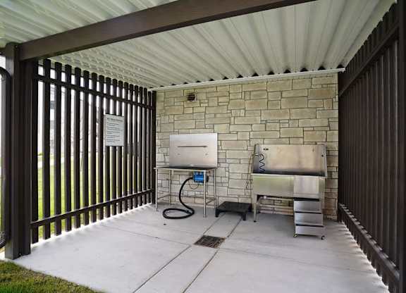 A patio with a sink and a grill.