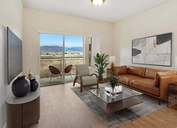 A living room with a brown couch, a glass coffee table, and a flat screen TV.