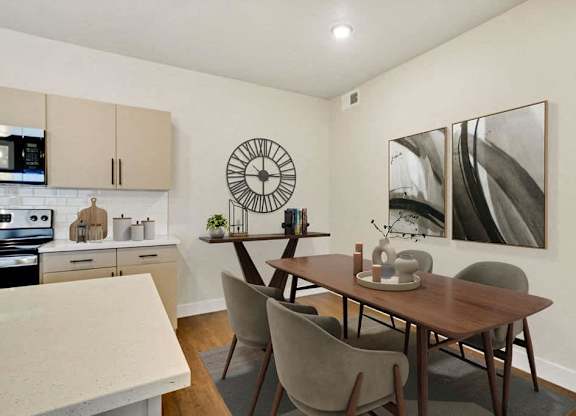 A dining room with a table and chairs.