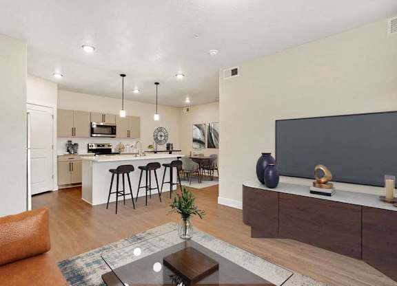 A modern living room with a bar area and a kitchen in the background.