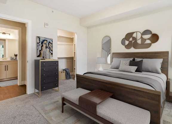 A bedroom with a large bed and a dresser.