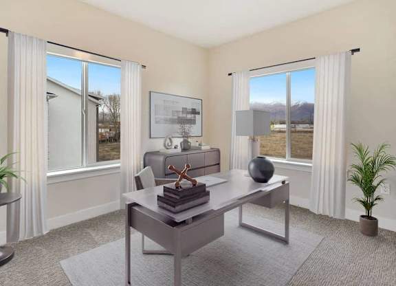 A room with a table, chairs, and a view of the outdoors through the windows.