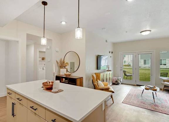 A modern kitchen with a white countertop and wooden cabinets.