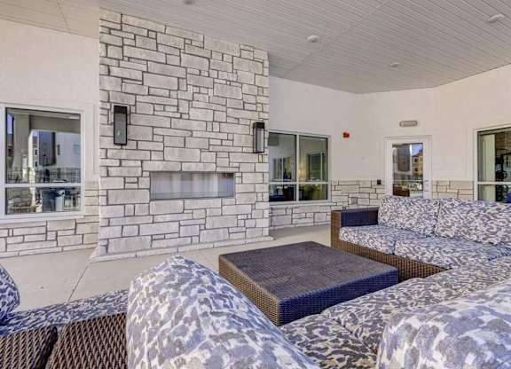 A stone fireplace is built into a wall in a living room.