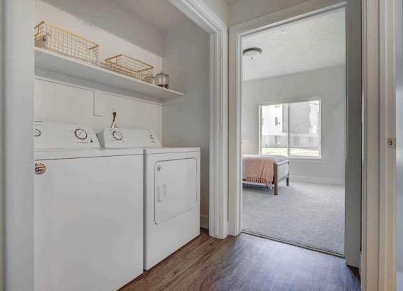 A white laundry room with a washer and dryer.