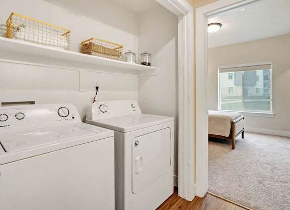 A small laundry room with a washer and dryer.
