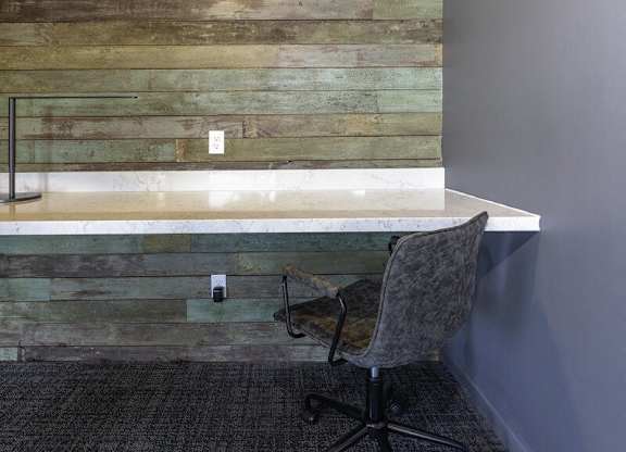 A chair is in front of a wooden wall.