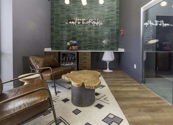 A modern living room with a glass backed sofa and a wooden coffee table.