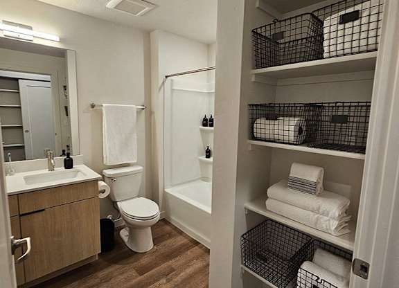A bathroom with a toilet, sink, and bathtub.