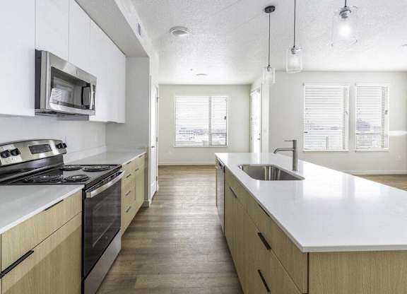 A kitchen with wooden cabinets and a stove top oven.