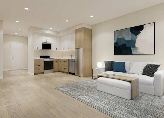 A modern living room with a white couch and a grey rug.