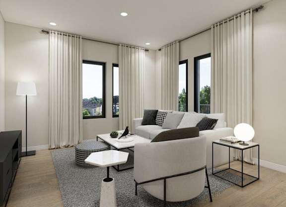 A modern living room with a grey sofa, a white coffee table, and a black floor lamp.
