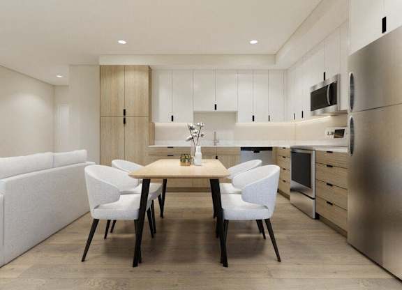A modern kitchen with a dining table and chairs.