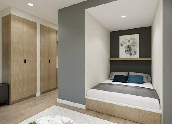 A bedroom with a bed, nightstand, and wardrobe.