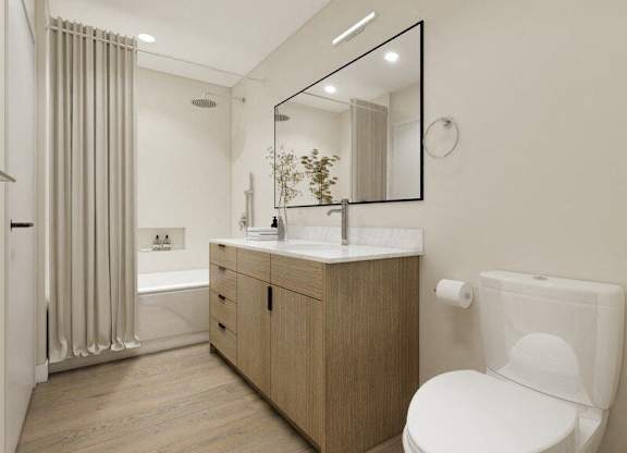 A modern bathroom with a wooden vanity and a white toilet.