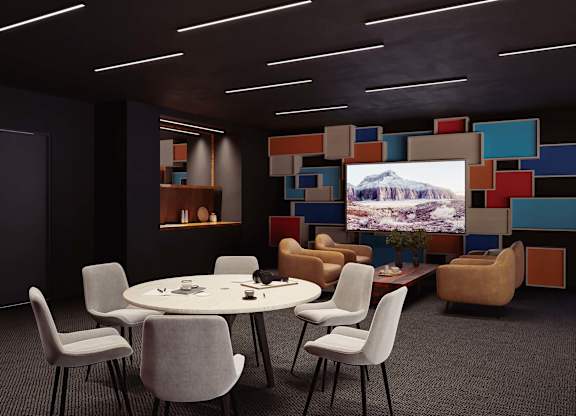 A conference room with a large screen displaying a mountain landscape.