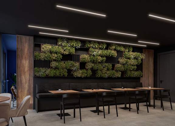 A modern dining area with a long table and chairs.