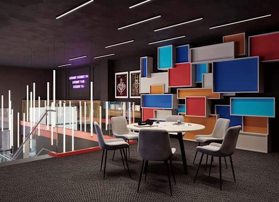 A modern conference room with a table, chairs, and a colorful wall.