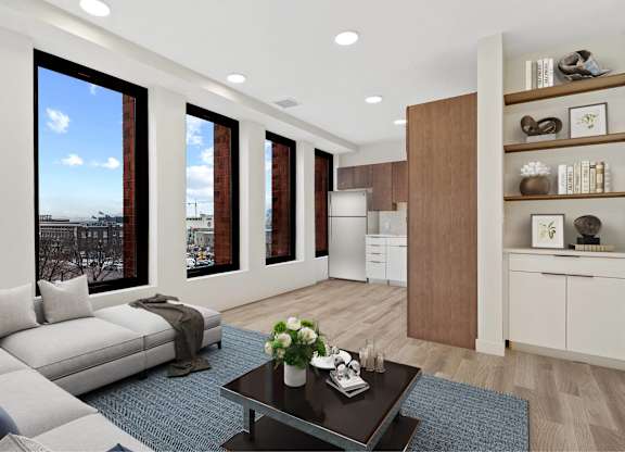 A modern living room with a large window overlooking the city.