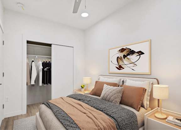 A bedroom with a bed, a nightstand, and a painting of a bird on the wall.