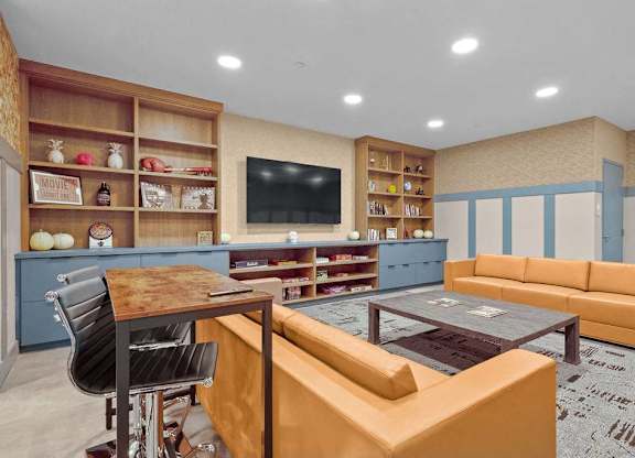 A living room with a brown table and a brown couch.