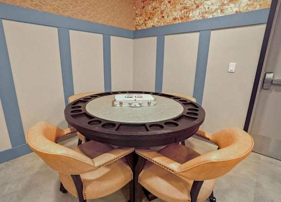 A round table with four chairs around it.