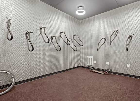 A room with a wall of ironing boards.