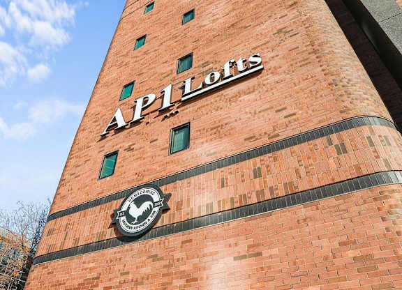 A tall red brick building with the word