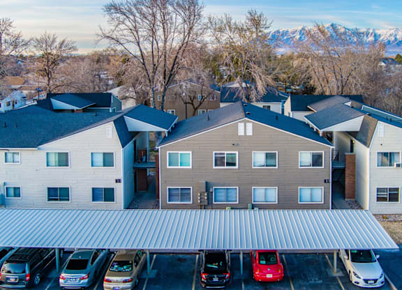 A parking lot with cars and a building in the background.