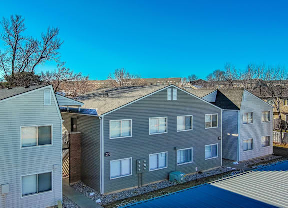 A row of houses with a blue sky above them.