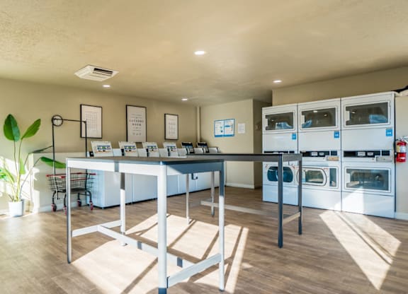 A kitchen with a table and chairs in the middle of the room.