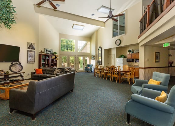 a living room with couches and chairs and a tv