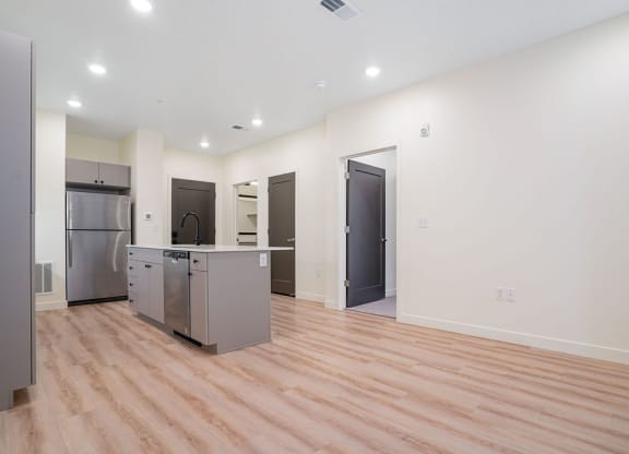 an empty kitchen with hardwood floors