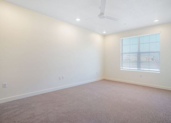 an empty bedroom with a window