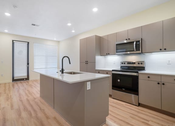 an empty kitchen with hardwood floors