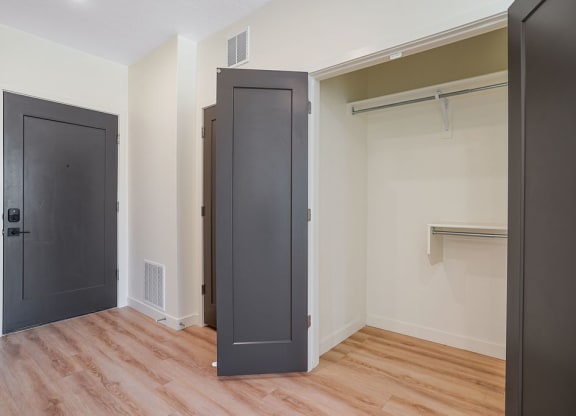 an empty closet with black doors
