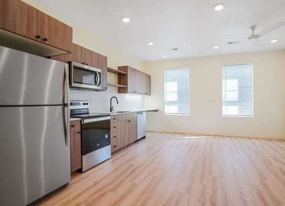 an empty kitchen with hardwood floors