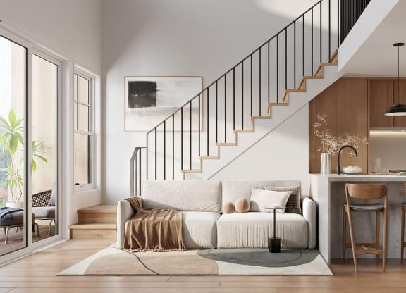 a kitchen with stairs and a white couch