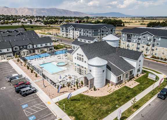 A large building with a pool in front of it.