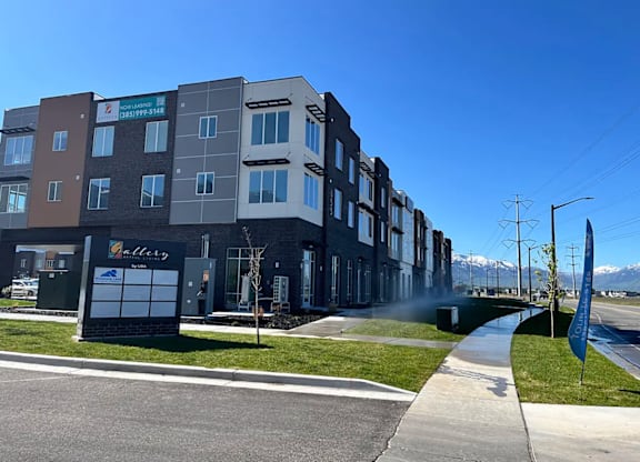 A row of modern apartment buildings with a clear blue sky above.