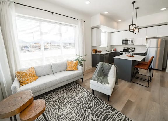 A modern kitchen with a white couch and a zebra print rug.
