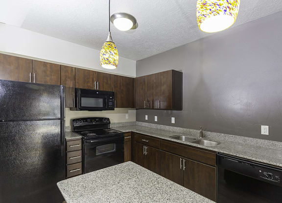 interior photo of a kitchen with brown cupboards from The Lotus Apartments in Downtown Salt Lake City, Utah