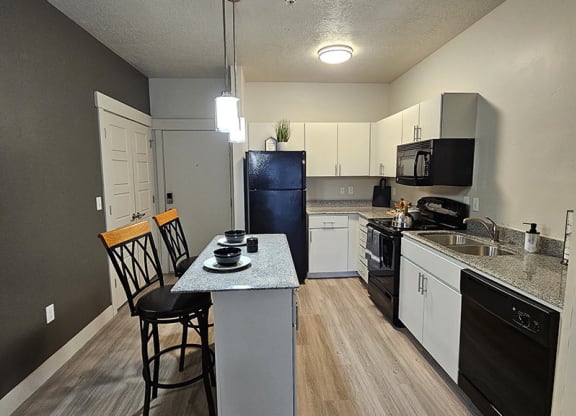 a kitchen with stools from The Lotus Apartments in Downtown Salt Lake City, Utah