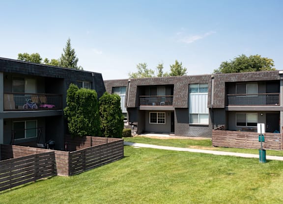 Apartment buildings with green lawns in front.