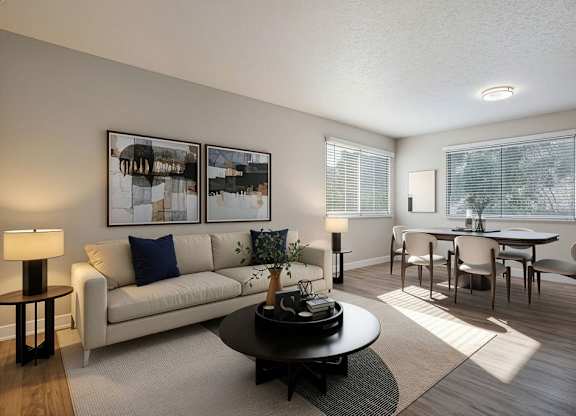 A living room with a couch, coffee table, and pictures on the wall.