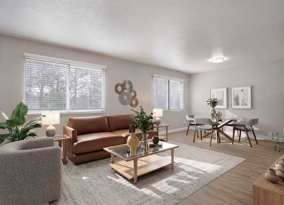 A living room with a grey sofa, a wooden coffee table, and a grey armchair.