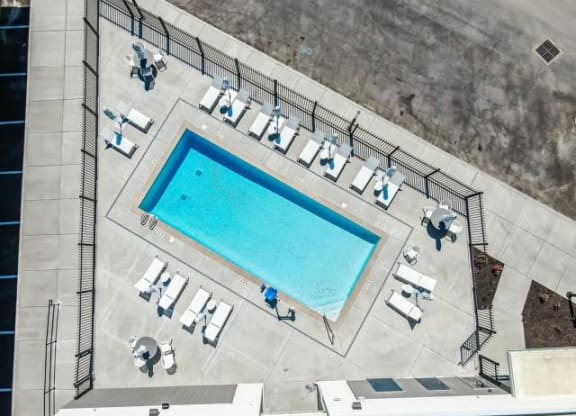 an overhead view of a swimming pool and chairs