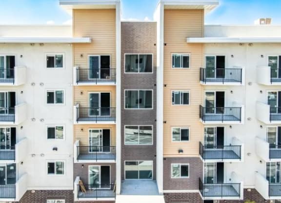 the facade of a modern apartment building with balconies