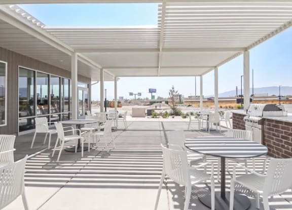 a patio with tables and chairs on a roof